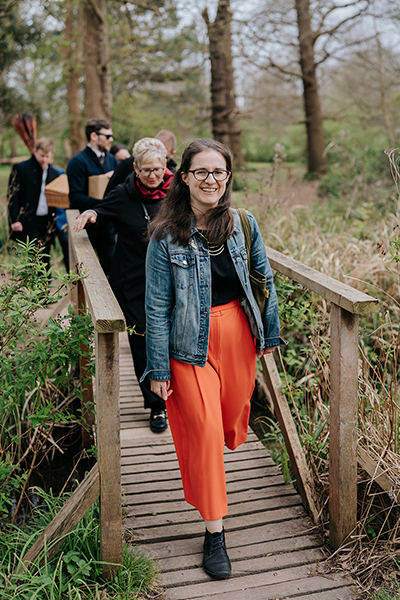 Steph Kendrick leads a group of people walking through the woods